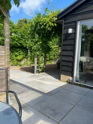a walkway leading to a house with a patio at Coast Holiday Appartements in Dirkshorn