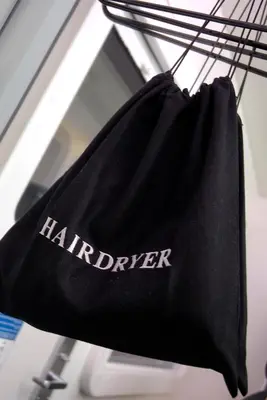 a black bag with the word harrier hanging on a wire at YOTELAIR Amsterdam Schiphol Transit Hotel in Schiphol