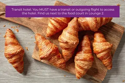 a wooden cutting board with a bunch of croissants at YOTELAIR Amsterdam Schiphol Transit Hotel in Schiphol