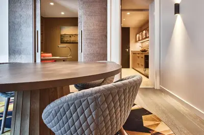 a dining room with a wooden table and chairs at Hyatt Regency Amsterdam in Amsterdam