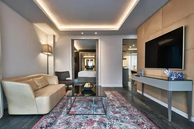 a living room with a couch and a tv at Hyatt Regency Amsterdam in Amsterdam
