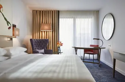 a hotel room with a bed and a desk at Hyatt Regency Amsterdam in Amsterdam