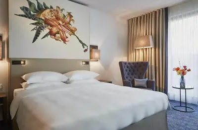 a hotel room with a bed and a chair at Hyatt Regency Amsterdam in Amsterdam