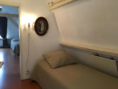 a clock on the wall above a bed in a room at La Perle Apartment in Utrecht