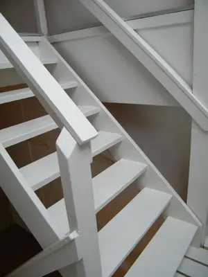 a white staircase with white shelves at La Perle Apartment in Utrecht