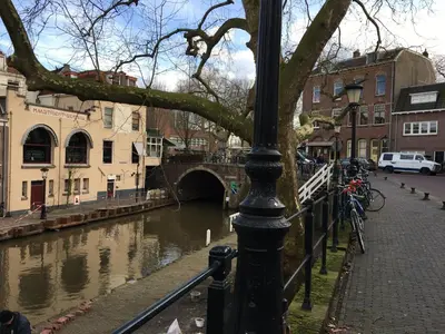 a street light next to a river with a bridge at La Perle Apartment in Utrecht