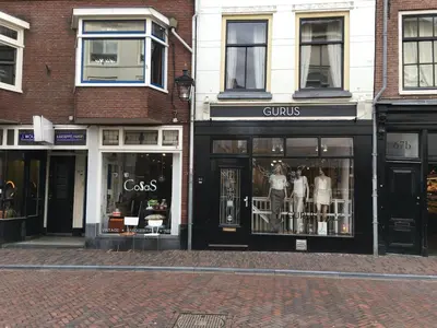 a store front with dresses in the windows on a street at La Perle Apartment in Utrecht