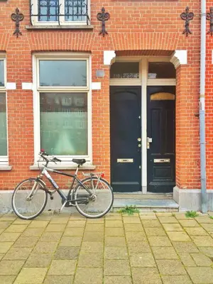 a bike parked in front of a brick building at Jordaan View in Amsterdam