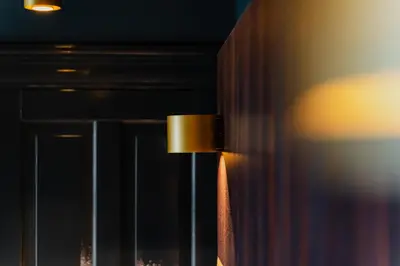 a close up of a lamp on a wall at De Jonker Urban Suites in Amsterdam