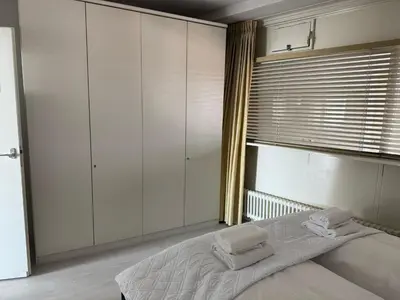 a bedroom with a bed with two towels on it at Seaview 15 in Zandvoort