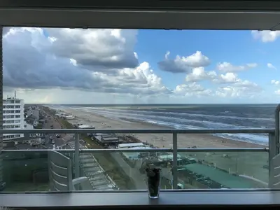 a view of the beach from a window of a condo at Seaview 15 in Zandvoort