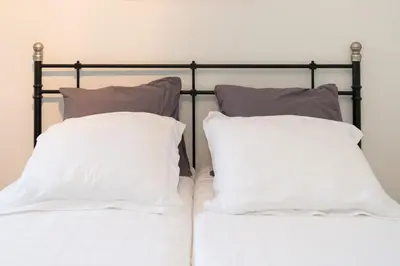 two pillows sitting on top of a bed at Old / New Pijp in Amsterdam