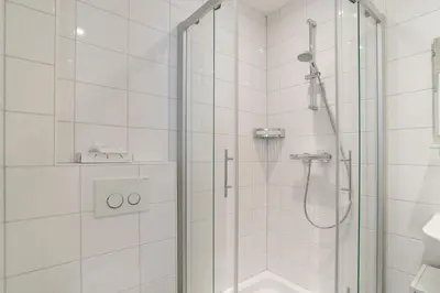 a bathroom with a shower with a glass door at Old / New Pijp in Amsterdam