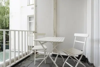 a table and two chairs on a porch at Old / New Pijp in Amsterdam