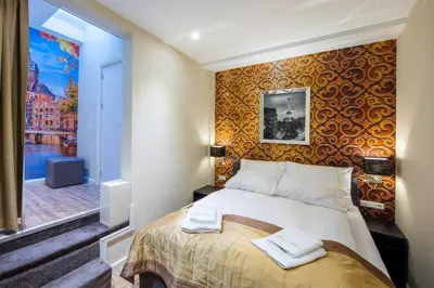 a hotel room with a bed and a window at Royal Plaza Hotel Amsterdam in Amsterdam