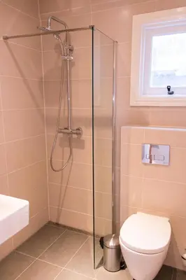 a bathroom with a shower and a toilet at Royal Plaza Hotel Amsterdam in Amsterdam