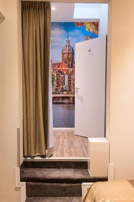 a room with a window with a view of a river at Royal Plaza Hotel Amsterdam in Amsterdam