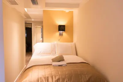 a small bedroom with a bed in a room at Royal Plaza Hotel Amsterdam in Amsterdam