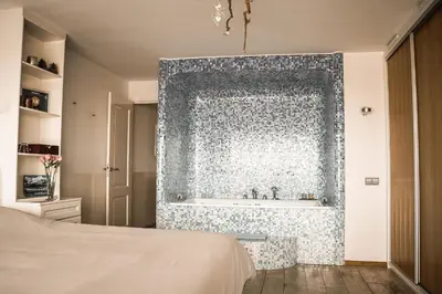 a bathroom with a shower with a bath tub at Vitamine Zee in IJmuiden