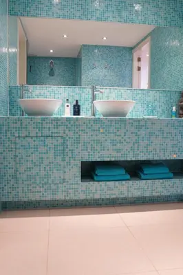 a bathroom with two sinks and a mirror at Vitamine Zee in IJmuiden