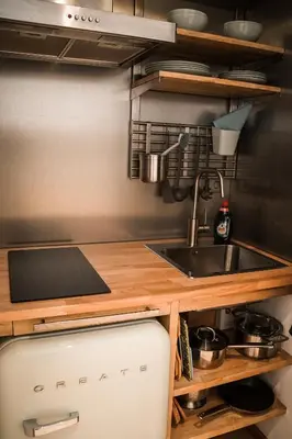 a kitchen with a sink and a counter at Vitamine Zee in IJmuiden