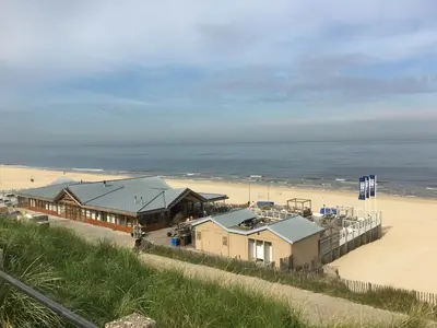 a row of houses on the beach next to a beach at Studio@25 in Zandvoort