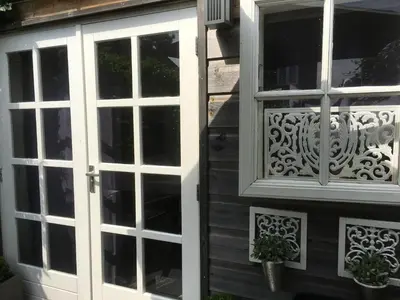 a white door and window on a house at Studio@25 in Zandvoort