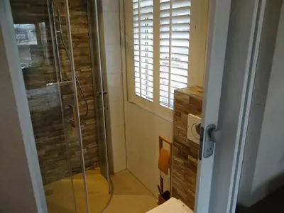 a shower in a bathroom with a glass shower stall at Villa La Vida in Egmond aan Zee