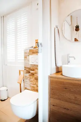 a bathroom with a white toilet and a sink at Villa La Vida in Egmond aan Zee