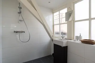 a bathroom with a shower and a sink at Rembrandt Studio's in Amsterdam