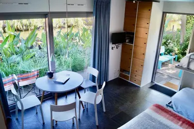 a room with a table and chairs and a bedroom at Room With A Few in Amsterdam