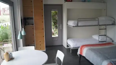 a room with two bunk beds and a table at Room With A Few in Amsterdam