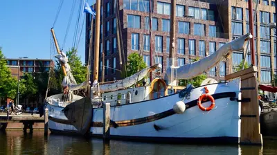 a boat is docked at a dock in the water at Room With A Few in Amsterdam