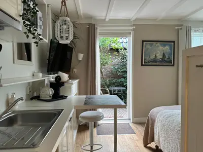 a kitchen with a sink and a counter top at Beach Holiday Appartements in Dirkshorn