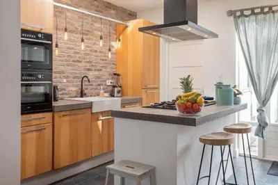 a kitchen with a counter with a bowl of fruit on it at Wijkiki Surf House in Wijk aan Zee