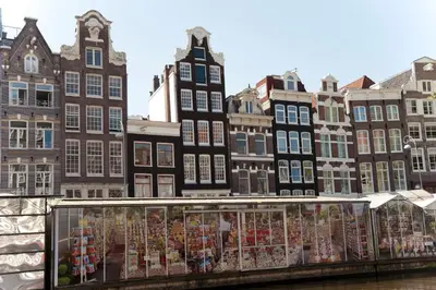 a bridge over a river with buildings in the background at Residence Flower Market in Amsterdam