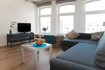 a living room with a couch and a table at Residence Flower Market in Amsterdam