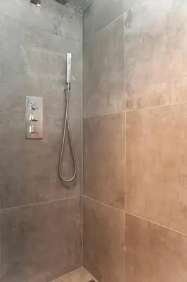 a shower with a shower head in a bathroom at Residence Flower Market in Amsterdam