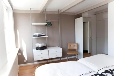 a bedroom with a bed and a chair at Residence Flower Market in Amsterdam