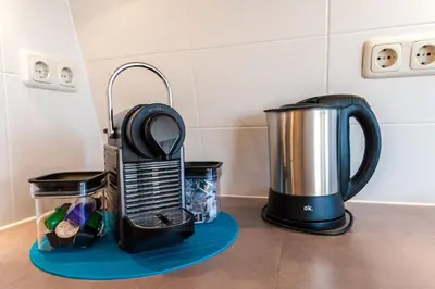 a kitchen counter with a coffee maker and a blender at Top Of The City in Amsterdam