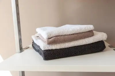 a stack of towels sitting on a shelf in front of a mirror at Top Of The City in Amsterdam