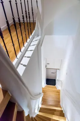 a staircase in a house with white walls and wooden floors at Top Of The City in Amsterdam