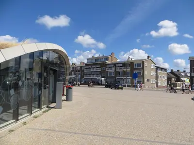 a group of people walking around a street at Appartement 5 in Katwijk aan Zee
