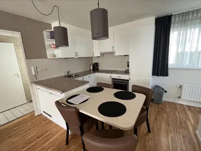 a kitchen with a table and chairs in a room at Appartement 5 in Katwijk aan Zee