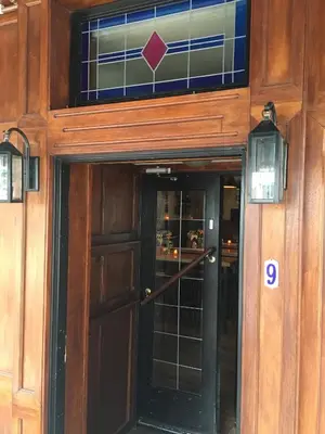 a door to a building with a sign on it at Beach Hotel Katwijk in Katwijk