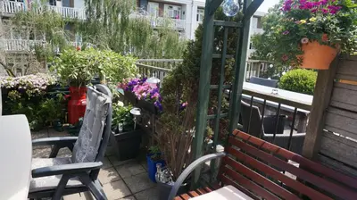 a garden with a bench and flowers and plants at Amsterdam Roof Terrace B&B in Amsterdam