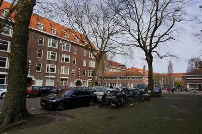 a group of motorcycles parked in a parking lot next to a building at Amsterdam Roof Terrace B&B in Amsterdam