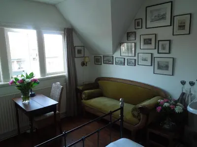 a living room with a couch and a table at Bed & Breakfast Frans Hals Haarlem in Haarlem