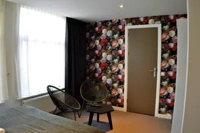 a bedroom with a mural of flowers on the wall at Hotel Heye 130 in Amsterdam