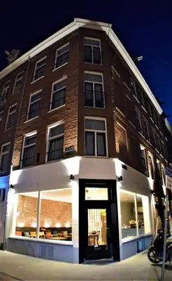 a large brick building with a store in front of it at Hotel Heye 130 in Amsterdam